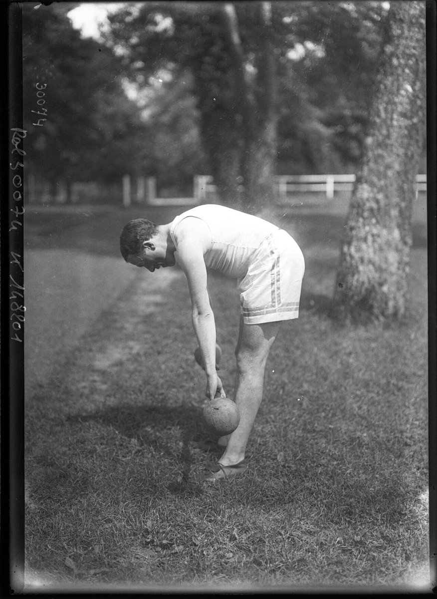 Athlète penché en avant sur la pelouse d'un stade, photographie de l'Agence Rol en 1913